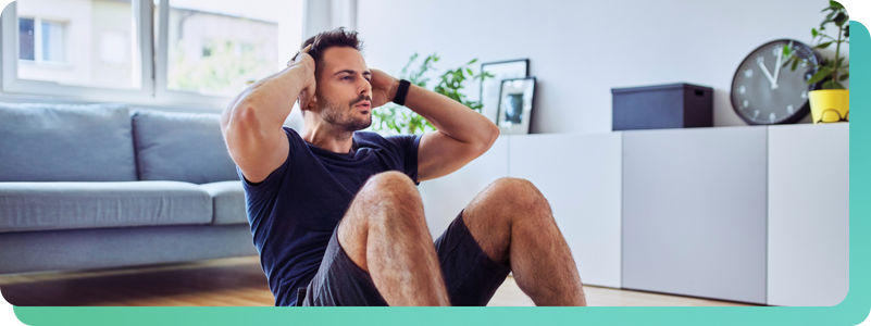 Man doing workout in living room with smart watch