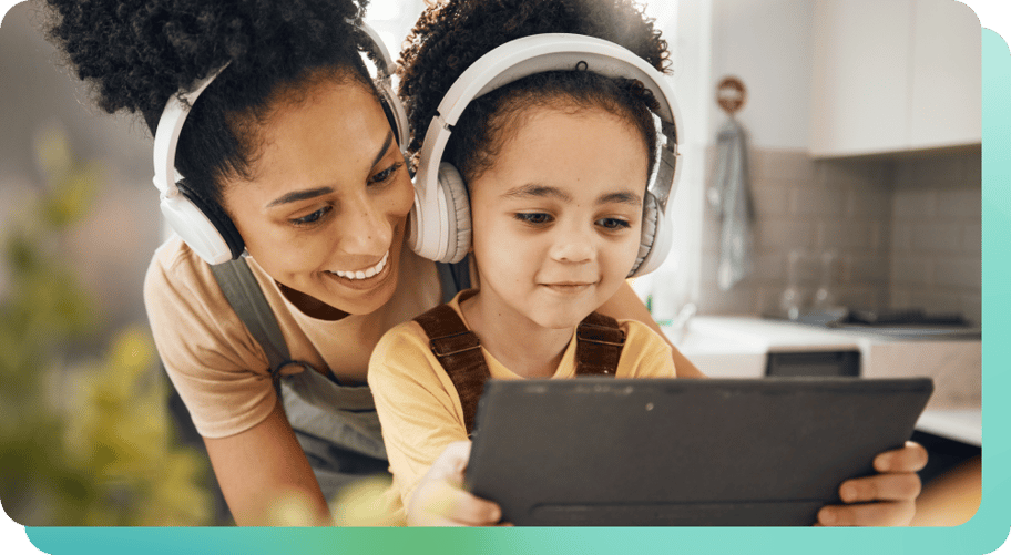 mother and child wearing headphones listening to music while engaging with smart tablet