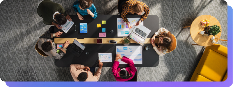 Business team working around table to figure our music licensing for social media