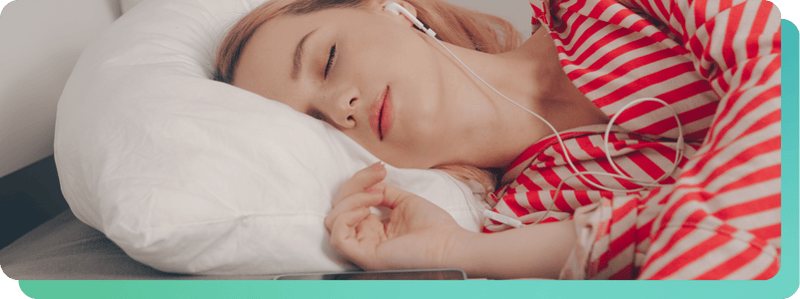 woman sleeping while listening to music